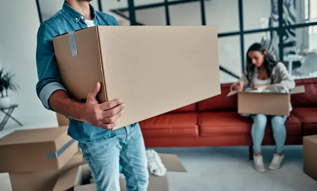 Photo d'un homme qui porte un carton